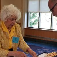 A woman hands a man a slice of cake